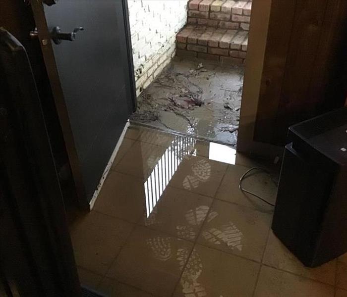 Basement stairs covered in mud all over tile floor