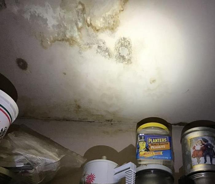 Ceiling in a laundry room with brown water stains