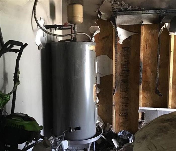 A water heater that caught on fire in a garage area